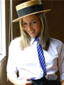 Melanie looking cheeky in a St. Trinians style college uniform.